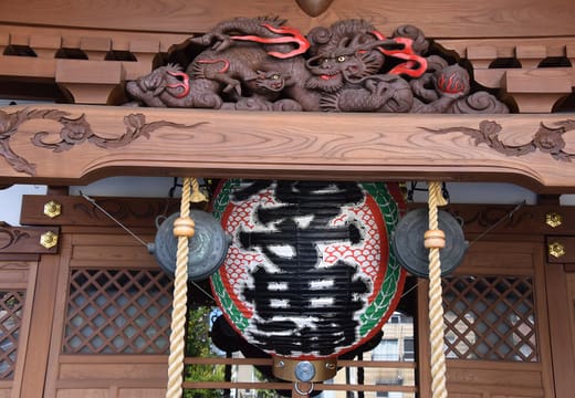 Ornate wooden altar entrance with dragon carving and lantern at Iriya Kishimojin temple