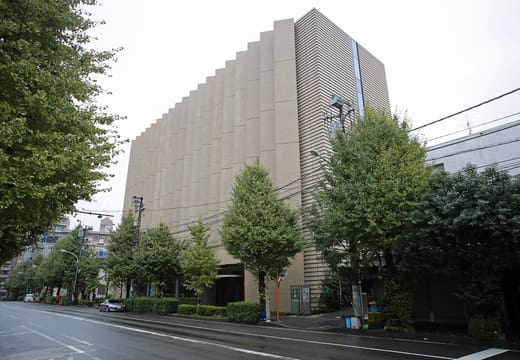 Stone-clad exterior of the Yamatane Museum of Art seen from the street in Hiroo