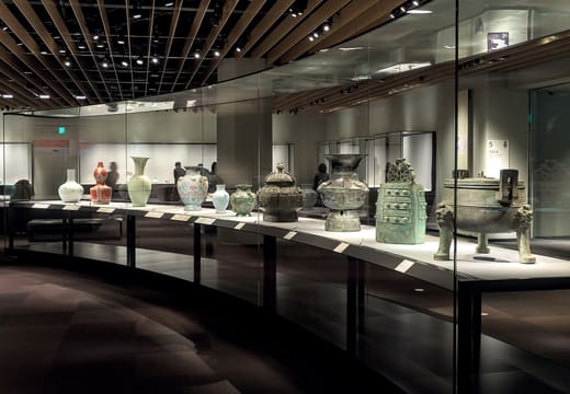 Display cases of Asian ceramics and bronzes inside the Toyokan at the Tokyo National Museum