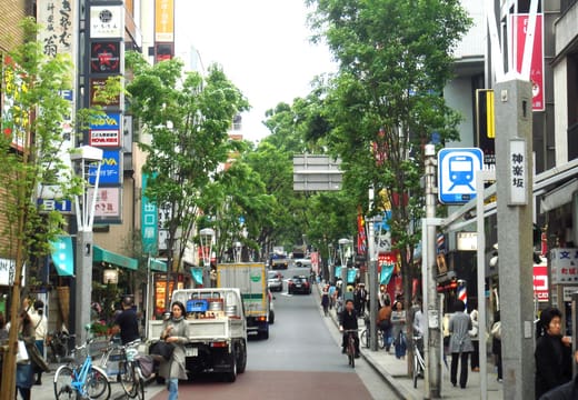 Shops and trees lining the Kagurazaka-dori slope climbing from Iidabashi Station