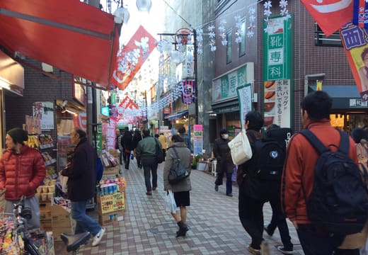 Residents shopping along the Jugo-dori shotengai in Sasazuka under festive street banners