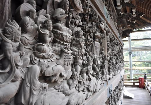 Intricate wood carvings covering the outer walls of the Shibamata Taishakuten main hall