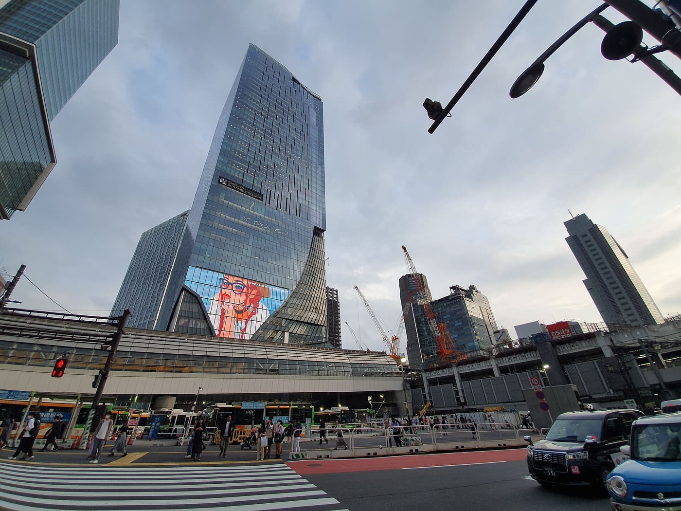 Shibuya Scramble Square tower rising above the station and the busy street below