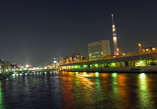Tokyo Skytree and the lit Sumida River seen from Kuramae Bridge at night
