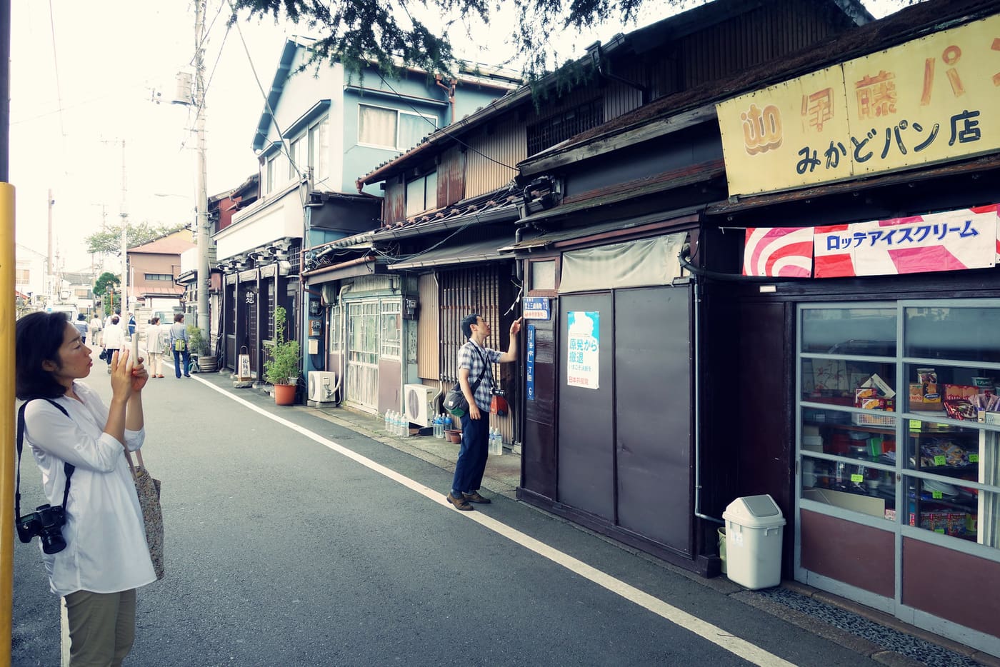 Old wooden shopfronts including the Mikado Pan bakery on a quiet Yanaka street