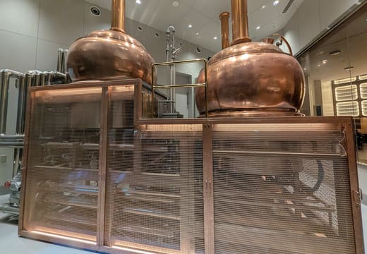 Copper brewing kettles behind glass at the Yebisu beer hall in Yebisu Garden Place