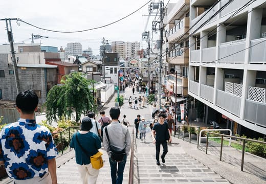 Shoppers descending the Yuyake Dandan steps into the Yanaka Ginza shopping street