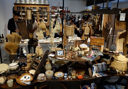 Crafted everyday objects crowding a display in an exhibition at 21_21 Design Sight