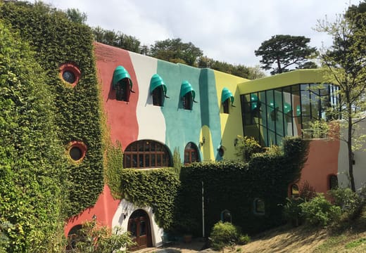 Ivy-covered pastel facade of the Ghibli Museum with round windows in Mitaka