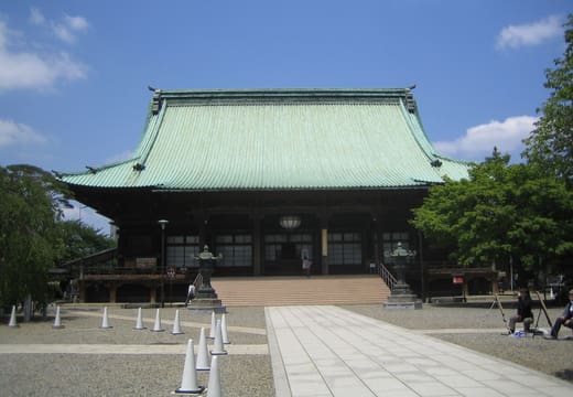 Main hall of Gokokuji Temple with its green copper roof across the stone courtyard, Bunkyo