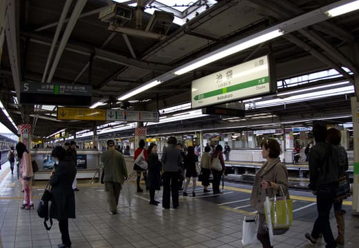 Commuters on a JR platform at Ikebukuro Station, one of the busiest stations in Tokyo