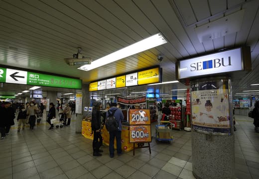 Seibu department store sign in the busy concourse of Ikebukuro Station