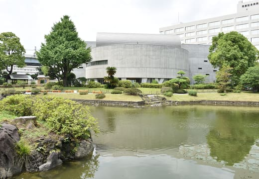 Japanese Sword Museum building seen across the pond of neighbouring Kyu-Yasuda Garden
