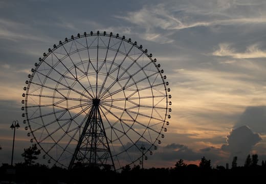 Diamond and Flower Ferris wheel silhouetted against a sunset sky at Kasai Rinkai Park