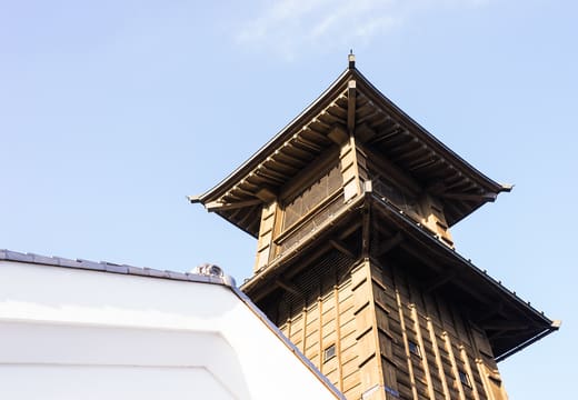 Wooden Toki no Kane bell tower against a blue sky in the old town of Kawagoe