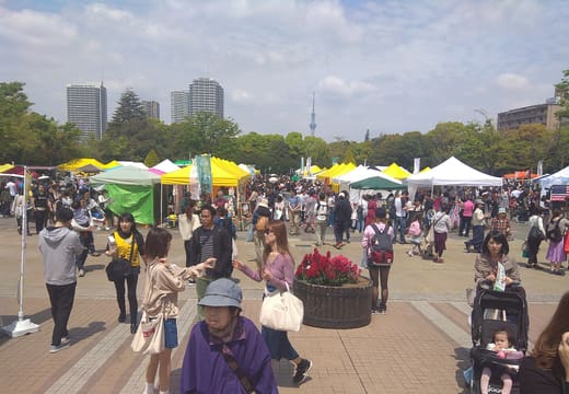 Crowds and food tents at a weekend festival on the central plaza of Kiba Park