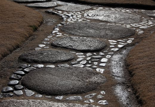 Round stepping stones set in pebbles along a path in Kiyosumi Gardens