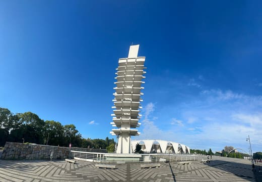 Wide central plaza of Komazawa Olympic Park with the memorial tower and gymnasium roof