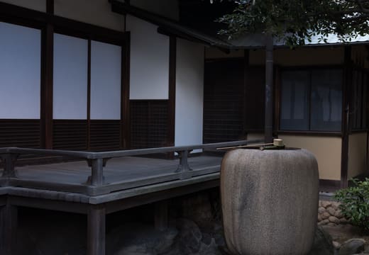 Wooden veranda and stone water jar at the Japanese-style wing of Kyu Iwasaki-tei