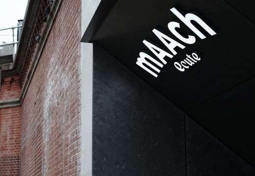 mAAch ecute logo sign on the red brick wall of the old Manseibashi railway viaduct