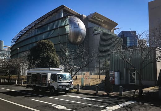 Curved glass building of Miraikan with the Geo-Cosmos globe visible inside, Odaiba