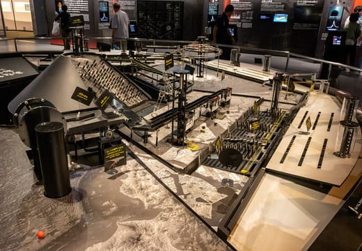 Large mechanical exhibit of tracks and towers on the display floor at Miraikan, Odaiba