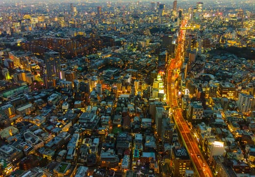 Evening traffic streams through the city lights seen from Roppongi Hills Mori Tower
