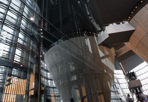 Giant inverted concrete cones rising through the atrium of the National Art Center Tokyo