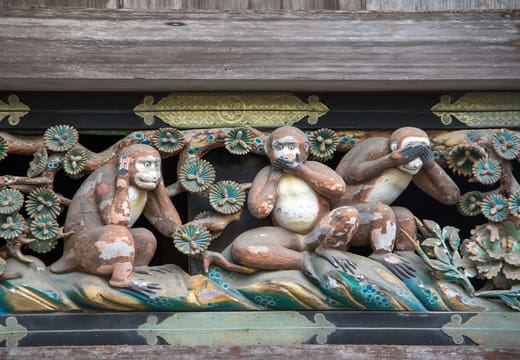 Carved three wise monkeys panel on the sacred stable at Nikko Toshogu