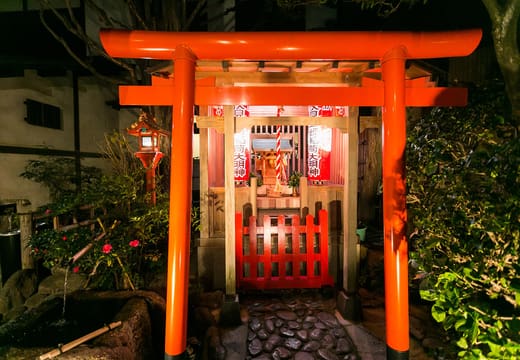 Small red torii and Inari shrine in the garden of the Obana unagi restaurant
