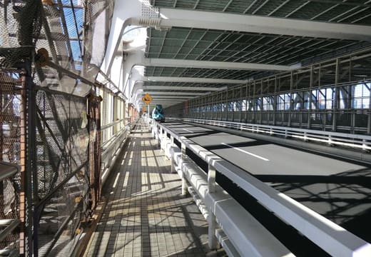 Pedestrian walkway running alongside the traffic deck of Rainbow Bridge over Tokyo Bay