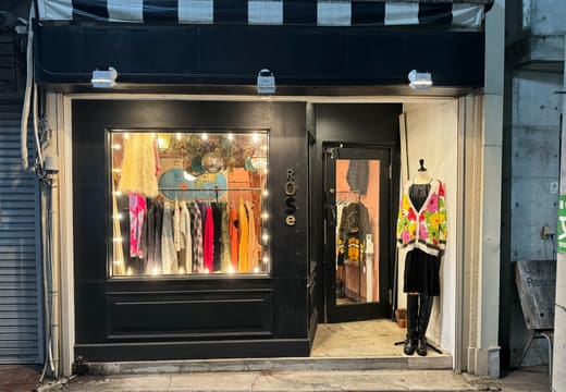Black shopfront of Rose Vintage clothing store with dresses in the window, Shimokitazawa