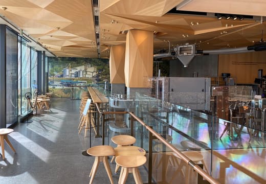Wood-ceilinged upper lounge with window seats at Starbucks Reserve Roastery Tokyo