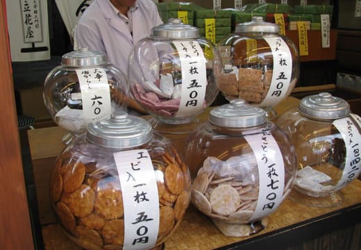 Glass jars of rice crackers for sale at a shop on Taishakuten Sando in Shibamata