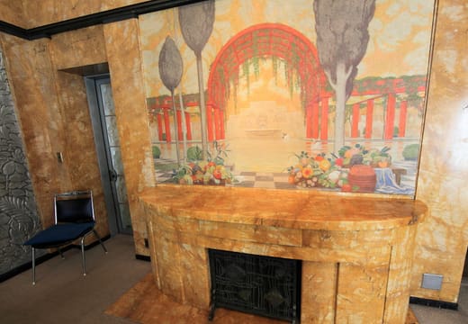 Marble fireplace below a painted mural in an Art Deco salon of the Teien Art Museum