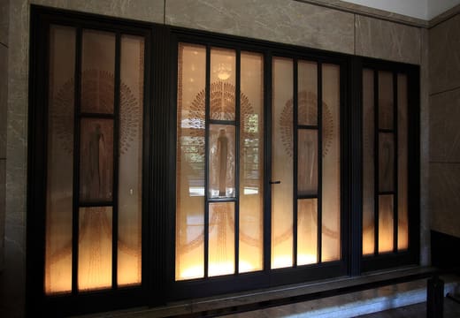 Etched glass entrance doors glowing inside the Art Deco Teien Art Museum, Shirokanedai