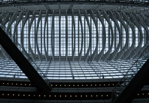 Looking up at the curved steel roof truss of the Tokyo International Forum Glass Hall