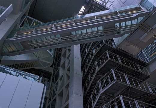 Glass-sided walkway bridge crossing the atrium of the Tokyo International Forum