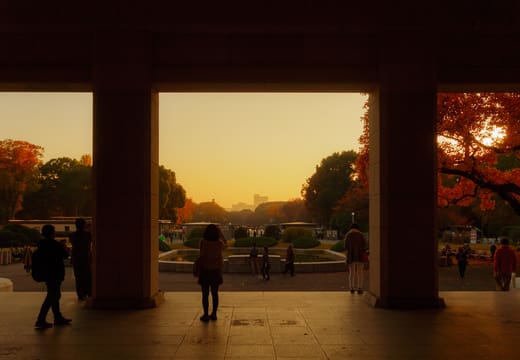 Visitors silhouetted in the doorway of the Tokyo National Museum at sunset in autumn