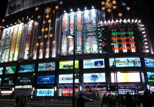 Yodobashi Akiba building decorated with Christmas lights and glowing ad screens at night