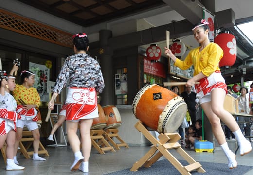 Taiko drummers performing on the stage during the Reitaisai festival at Yushima Tenman-gu