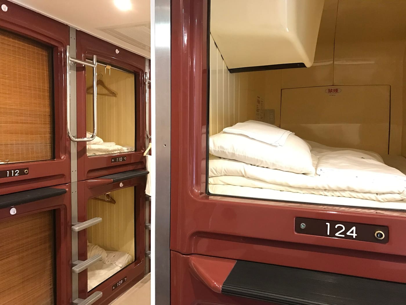 Rows of numbered sleeping pods in a capsule hotel in Tokyo