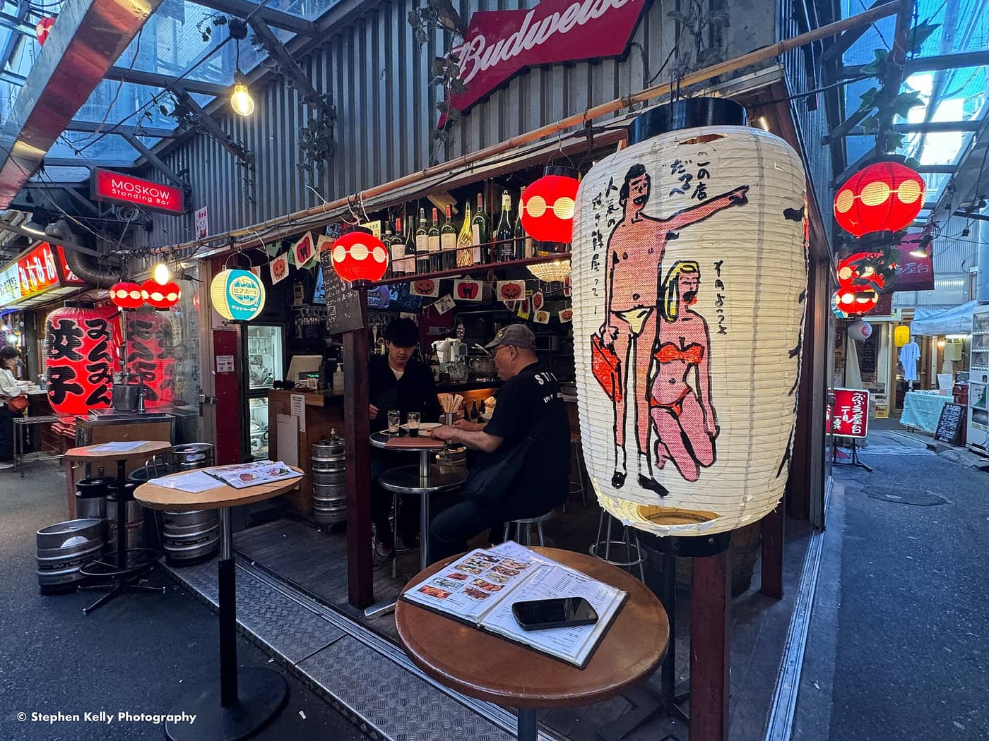 Drinkers at a lantern-hung bar in the Harmonica Yokocho alleys of Kichijoji