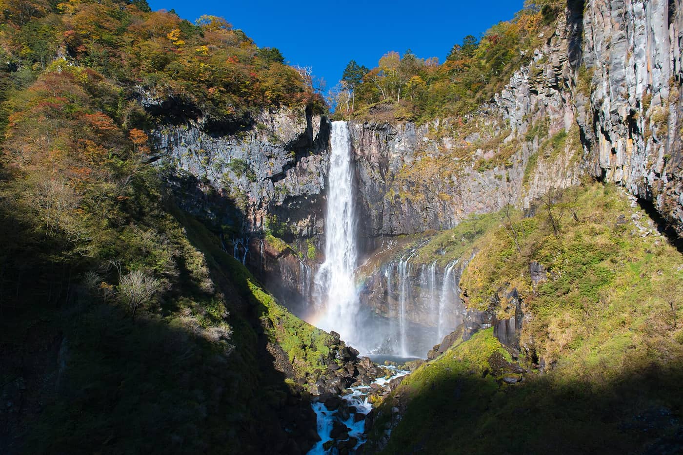 Kegon Falls in Nikko with autumn colour on the cliffs around the gorge