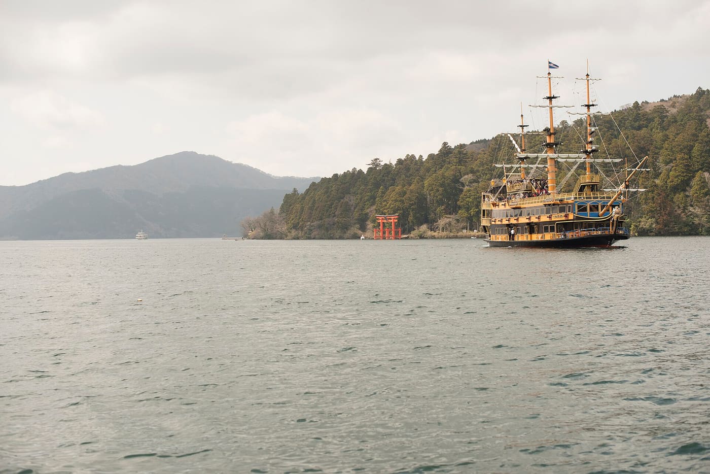 A Hakone sightseeing pirate ship on Lake Ashi with the shrine torii on the shore