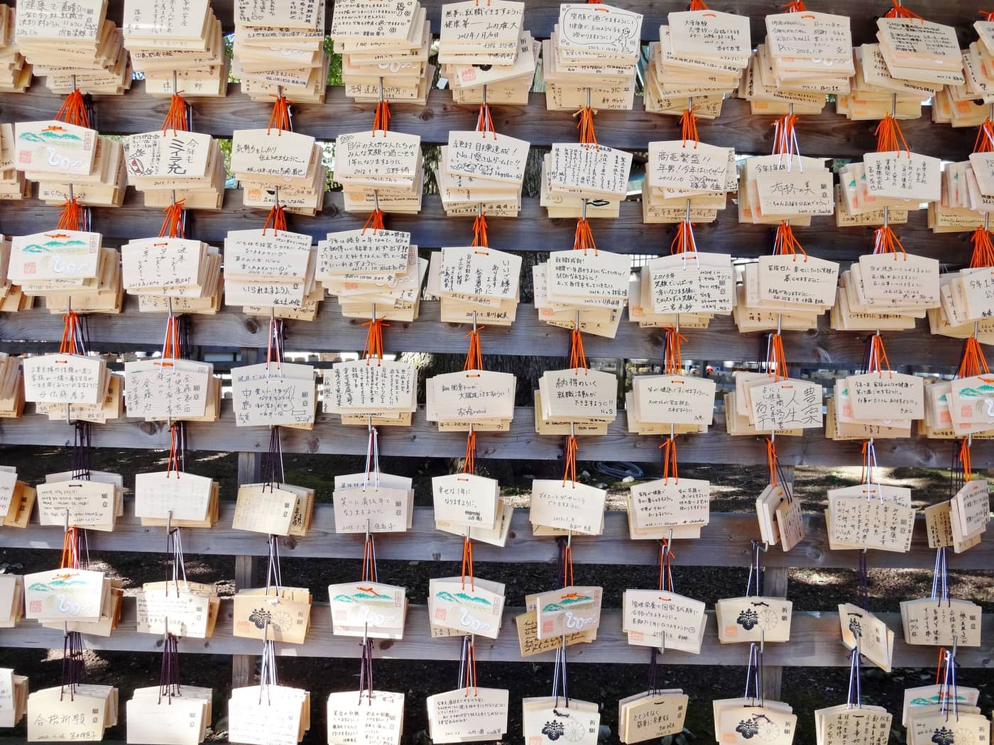 Rows of wooden ema wishing plaques hung at Meiji Shrine in the New Year season