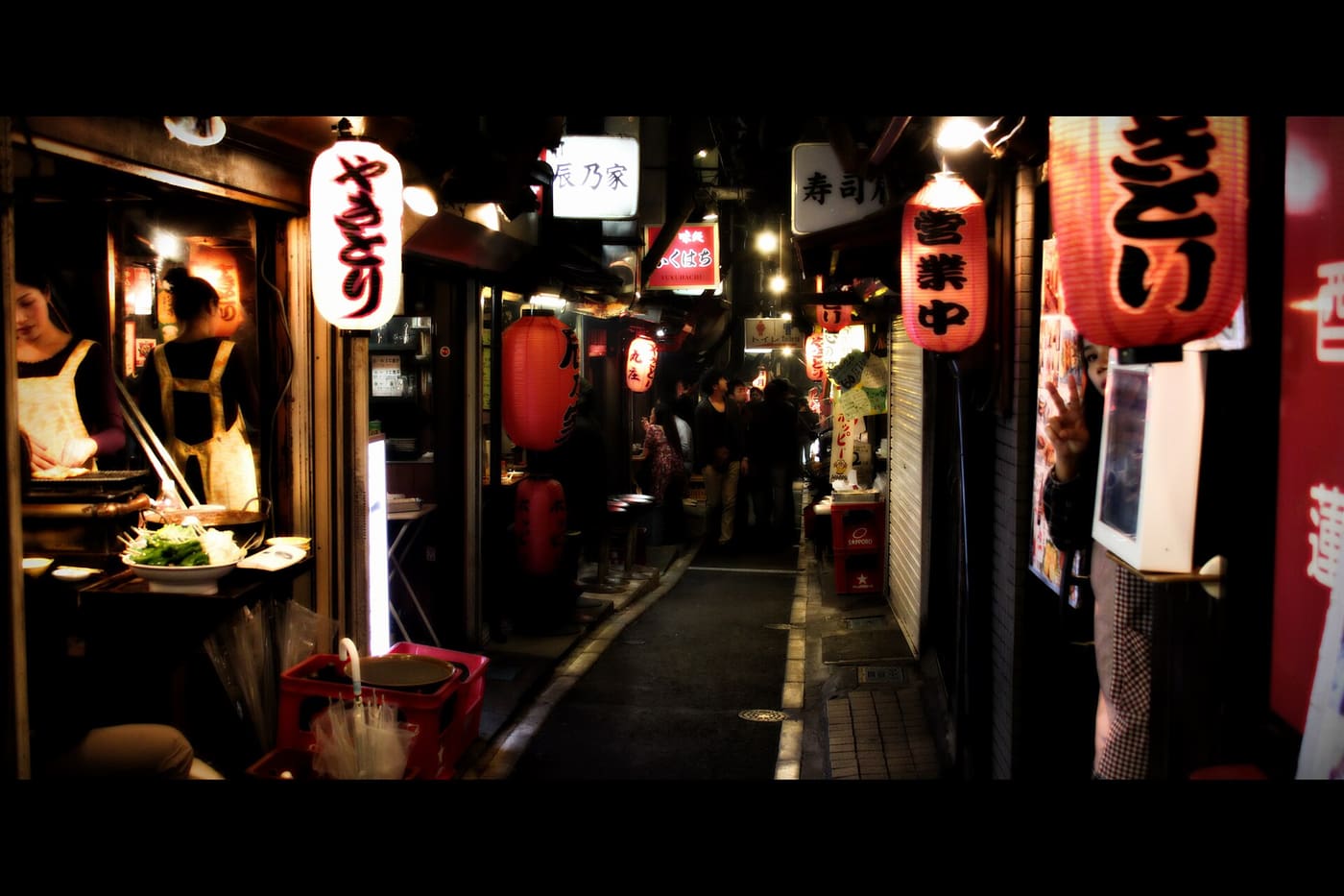 Red lanterns outside tiny yakitori shops in Omoide Yokocho, Shinjuku, at night