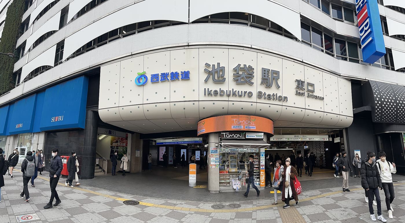 The Seibu Ikebukuro Station east exit with shoppers crossing the plaza outside