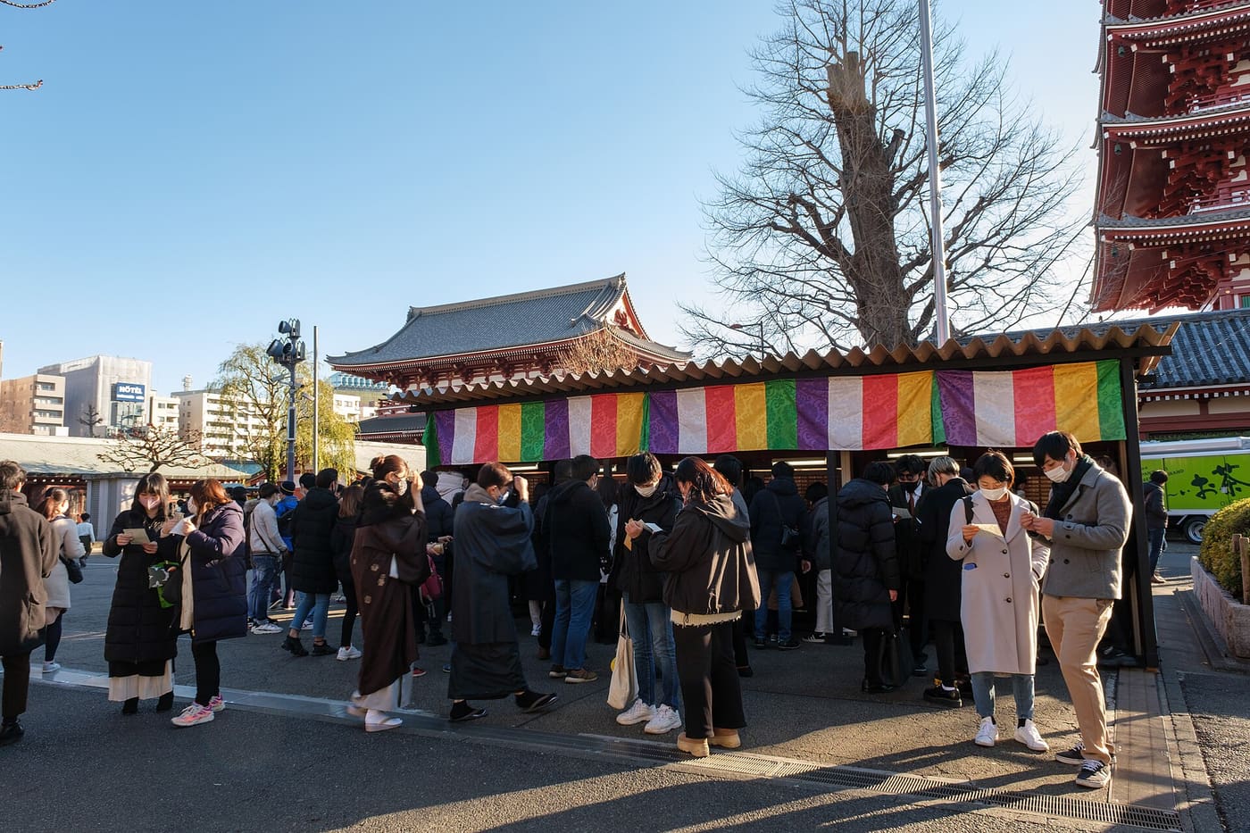 Visitors crowding the omikuji fortune slip stand at Senso-ji in Asakusa on New Year's Day