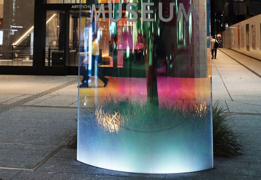 The lit glass sign of the Artizon Museum outside its entrance in Kyobashi at dusk